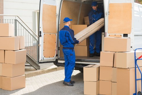 Team preparing a safe home move with packing and lifting precautions