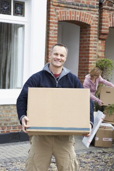 Movers handling boxes during a home relocation in Earls Court