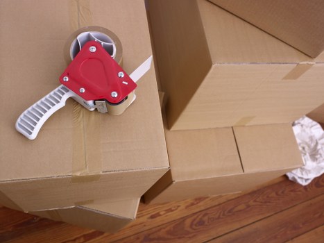 Furniture pick-up van loaded with mixed household items near Earls Court
