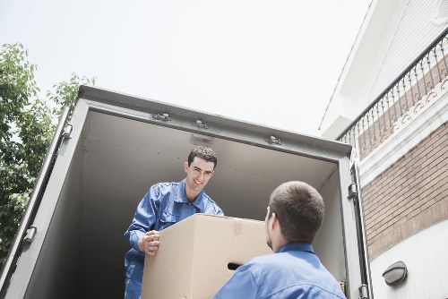 Packed household boxes and furniture ready for loading in Earls Court