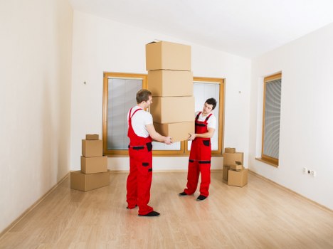 Packed moving boxes and furniture ready for transport in West London