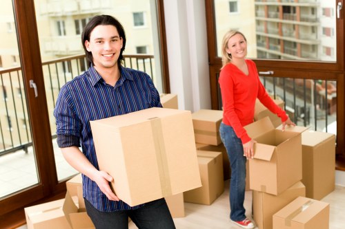 Local movers handling office equipment in a busy Earls Court street